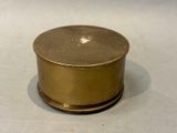 a small brass box sitting on a white surface