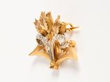 an image of a gold and diamond flower broochle on a white background