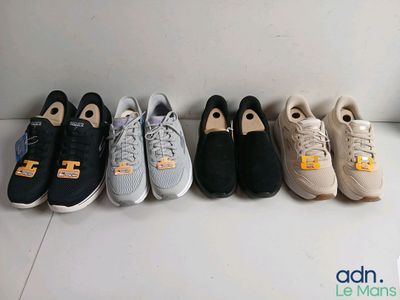 several pairs of tennis shoes lined up in a row on the floor
