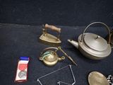 a tea pot, tea kettle, a tea bag, and other items on the floor