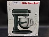 packaging of a kitchenaid mixer sitting on a table in front of a black background