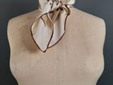 a close up of a mannequin torso with a scarf on it