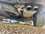 a close up of a car ' s exhaust pipe and exhaust muffler