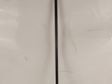 a close up of a black metal handle on a white wall