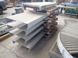 several pieces of metal are stacked on top of each other in a warehouse