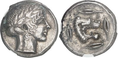 a close up of a silver coin with a head of a woman on it