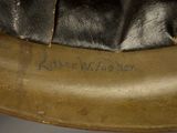 a close up of a leather hat with writing on it