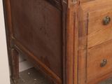 a wooden dresser with a vase on top of it