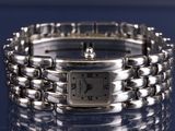 a close up of a silver wrist watch on a table