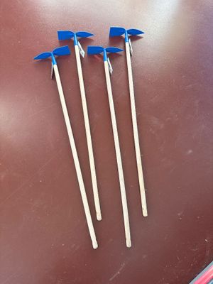 three tooth picks sitting on top of a brown table