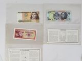 several different types of currency are displayed on a white surface