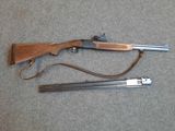 an old gun and a shotgun on a gray surface