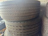tires stacked on top of each other next to a wall