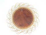 a wooden plate with a decorative design on top of it