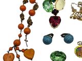 a lot of jewelry that is laying out on a white surface