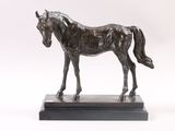 a statue of a horse that is standing on a base