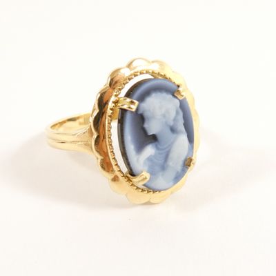 an image of a gold ring with a blue stone in the center
