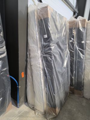 several pieces of furniture are wrapped up in plastic and ready to be shipped