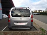 a silver van that is parked in a parking lot