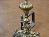 a metal table with a gold top and a black base