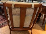 a chair that is sitting in a room with a rug