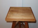 a small wooden table with a wooden top on a wooden floor