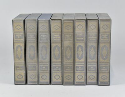 six books in a row on a white surface
