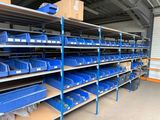 shelves with blue bins and boxes in a storage room