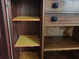 a wooden cabinet with shelves on top of it