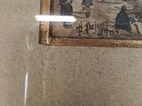 a picture of a painting on the wall above a toilet