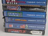 several video games stacked on top of each other on a white surface