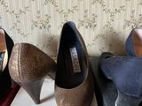 three pairs of women ' s shoes are lined up on a shelf