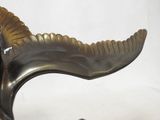 bronze sculpture of a bird on a wooden base on a white background