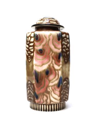 a vase that has a lid on it on a white surface