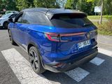 the rear end of a blue suv parked on the side of the road