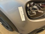 a close up of a car ' s headlight with a sticker on it