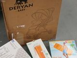 a box of baby products sitting on the floor next to a box of books