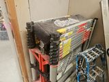 a stack of tools sitting on the floor next to a refrigerator