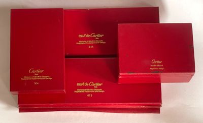 four red boxes with gold lettering on them sitting on a white surface