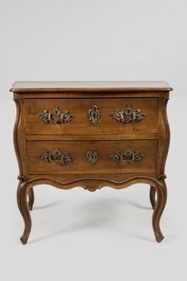 a small wooden chest of drawers on a white background