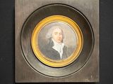 tableau représentant un homme en manteau noir, dans un cadre doré, sur fond noir