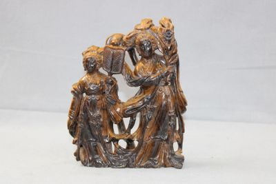 an antique bronze figurine of a man and woman with a basket