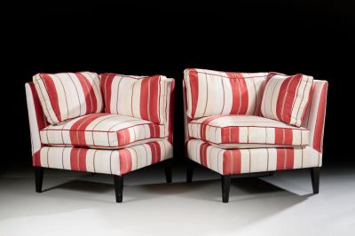 pair of red and white striped chairs against a black background