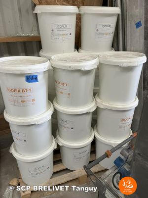 several buckets of white paint sitting on top of a wooden pallet
