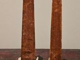 two pieces of wood that have been carved into the shape of obelisks
