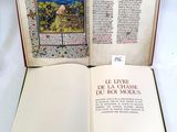 an open book with a picture of a village on it