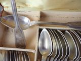 spoons, forks, and spoons are in a wooden box