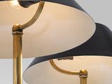 a pair of black and gold floor lamps on a white background
