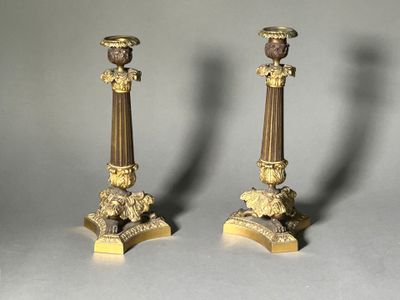 pair of antique brass candlesticks with lion heads on bases