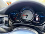 a close up of a car dashboard with various gauges